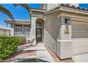 Beautiful home showcasing desert landscaping, arched entryway, and textured stucco walls at 2470 Lower Meadows Ave, Henderson, NV 89052
