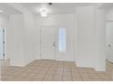 Bright and airy entrance hall with neutral tile flooring, fresh white walls, and plenty of natural light at 2573 Grandville Ave, Henderson, NV 89052