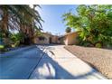 Well-maintained single-level home with mature trees, desert landscaping, and a large driveway at 2612 Sonora St, Las Vegas, NV 89102