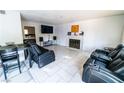 Relaxing living room with white tile flooring, comfortable seating, and a cozy fireplace at 2612 Sonora St, Las Vegas, NV 89102