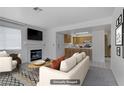 The open-concept living space features a fireplace, and seamless flow into the adjacent kitchen at 2725 S Nellis Blvd # 1056, Las Vegas, NV 89121