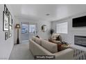 Bright living room featuring neutral tones, fireplace, and sliding glass doors to a private balcony at 2725 S Nellis Blvd # 1056, Las Vegas, NV 89121