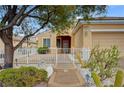Inviting single-story home with desert landscaping and a cozy front porch with seating at 2820 Goldcreek St, Henderson, NV 89052