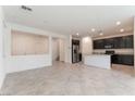 Spacious living room with tile flooring and a view into the kitchen area for open concept living at 2824 Mozia Ct, Henderson, NV 89044