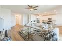 Open floor plan with a modern kitchen, living room with a decorative rug, and wood flooring at 2935 Gaffer Film St, Las Vegas, NV 89156