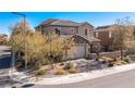 Corner lot featuring a two-story home with desert landscaping, a two-car garage and decorative stone facade at 436 Trevinca St, Las Vegas, NV 89138
