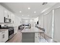 Open-concept living area boasts a modern kitchen, comfortable seating, and a seamless flow, great for entertaining at 4526 Cloudrest Peak St, North Las Vegas, NV 89031