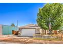 Charming single-story home featuring a two-car garage, neat landscaping and a quaint wooden fence at 474 Adelle Ave, Overton, NV 89040