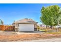 Charming single-story home featuring a two-car garage, neat landscaping and a quaint wooden fence at 474 Adelle Ave, Overton, NV 89040