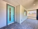 Covered entryway showcasing a stylish blue front door and brick-paved flooring at 483 Fairview Hills St, Las Vegas, NV 89138