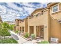 Street view of well-maintained townhomes with sidewalks and inviting landscaping at 49 Alamere Falls Dr, Las Vegas, NV 89138