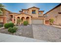 Inviting two-story home with a brick-paved driveway, well-kept landscaping, and a warm, neutral color palette at 4937 Teal Petals St, North Las Vegas, NV 89081