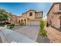 Attractive two-story home boasting a paved driveway, tidy landscaping, and a welcoming front facade at 4937 Teal Petals St, North Las Vegas, NV 89081