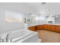 Luxurious bathroom with soaking tub, double sinks, and vanity area at 5396 Valley Wells Way, Las Vegas, NV 89113
