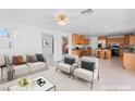 Open-concept living room and kitchen with stainless steel appliances and breakfast bar at 5396 Valley Wells Way, Las Vegas, NV 89113