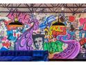 Living room showcasing modern graffiti art and blue velvet sofa at 5626 Deer Creek Falls Ct, Las Vegas, NV 89118