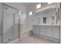 Bright bathroom featuring a glass enclosed shower, soaking tub and double sink vanity at 6436 Point Break St, North Las Vegas, NV 89084