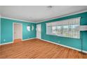 Inviting living room features laminate floors, turquoise walls and plenty of natural light at 7 Church St, Henderson, NV 89015