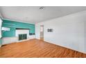 Bright living room with wood floors, shiplap accent wall, and a cozy fireplace at 7 Church St, Henderson, NV 89015