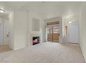 Inviting living room features a cozy fireplace, patio access, and natural light at 8805 Jeffreys St # 2020, Las Vegas, NV 89123