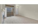 Bright living room boasts patio access, neutral paint and plush carpeting at 8805 Jeffreys St # 2020, Las Vegas, NV 89123