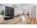 Bright and airy living room with a fireplace, comfortable seating, and a view of the staircase and dining area at 9115 Weeping Hollow Ave, Las Vegas, NV 89178