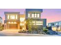 Contemporary home exterior showcasing modern design and a well-manicured front yard at 10718 Desert Heights Ave, Las Vegas, NV 89135