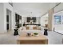 Open-concept living room with stylish furnishings and seamless flow to the kitchen area at 10718 Desert Heights Ave, Las Vegas, NV 89135