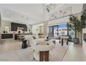 Bright, open-concept living space with soaring ceilings, stylish furnishings, and seamless indoor-outdoor flow at 10718 Desert Heights Ave, Las Vegas, NV 89135