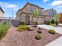 Attractive home with desert landscaping, a two-car garage, and a secure front gate at 1124 Aspen Cliff Dr, Henderson, NV 89011