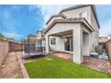 Cozy backyard featuring an artificial lawn, trampoline and covered patio at 1267 Dorado Sea Ct, Henderson, NV 89052