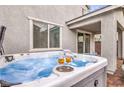 Close up of a hot tub on a patio with two glasses of champagne at 1267 Dorado Sea Ct, Henderson, NV 89052