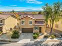 Charming two-story home with a well-maintained lawn, mature landscaping, and a classic brown garage door at 1813 Arch Stone Ave, North Las Vegas, NV 89031