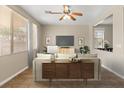 Inviting living room with tile floors, neutral paint, modern furniture, and lots of natural light at 1813 Arch Stone Ave, North Las Vegas, NV 89031