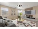 Comfortable living room with modern furniture, TV, ceiling fan, and abundant natural light at 1813 Arch Stone Ave, North Las Vegas, NV 89031
