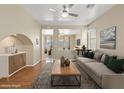 Open-concept living room with modern decor, ceiling fan, and seamless transition to the adjacent spaces at 1813 Arch Stone Ave, North Las Vegas, NV 89031