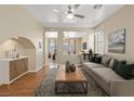 Bright living room with hardwood floors, neutral walls, stylish furniture, and plenty of natural light at 1813 Arch Stone Ave, North Las Vegas, NV 89031