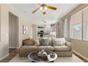 Cozy living room with a view of kitchen, neutral paint, modern furniture, and lots of natural light at 1813 Arch Stone Ave, North Las Vegas, NV 89031