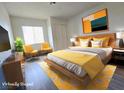 Cozy bedroom featuring a queen bed, colorful artwork, and natural light at 2191 Bay Club Dr # 102, Laughlin, NV 89029
