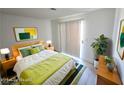 Bright bedroom with a bed, wooden nightstands, and vibrant green accents at 2191 Bay Club Dr # 102, Laughlin, NV 89029