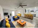 Bright living room with modern furniture, fireplace, and ceiling fan at 2191 Bay Club Dr # 102, Laughlin, NV 89029