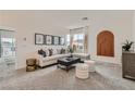 Bright living room with neutral decor, stylish furniture, and large windows at 240 White Crest Peak Ave, Henderson, NV 89015