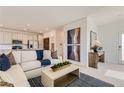 Open-concept living room with modern furnishings, flowing into a bright kitchen at 240 White Crest Peak Ave, Henderson, NV 89015
