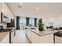 Modern kitchen boasts stainless steel appliances, center island, and open layout at 242 White Crest Peak Ave, Henderson, NV 89015