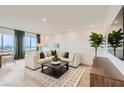 Spacious living room showcasing neutral colors, plush seating, and large windows with views at 242 White Crest Peak Ave, Henderson, NV 89015