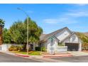 Corner lot home with a well-maintained lawn, mature trees, and a cozy, inviting facade at 2513 Aberdeen Ln, Henderson, NV 89014