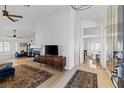 Bright open-concept living room featuring hardwood floors, a fireplace, and a modern design at 2513 Aberdeen Ln, Henderson, NV 89014