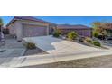 Charming home with a concrete driveway and desert landscaping for easy upkeep at 2613 Velodrome Ct, Henderson, NV 89044