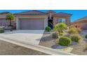 Charming home with a two-car garage and meticulously landscaped front yard at 2613 Velodrome Ct, Henderson, NV 89044