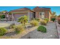 Well-maintained desert landscaping adds curb appeal to this beautiful property at 2613 Velodrome Ct, Henderson, NV 89044
